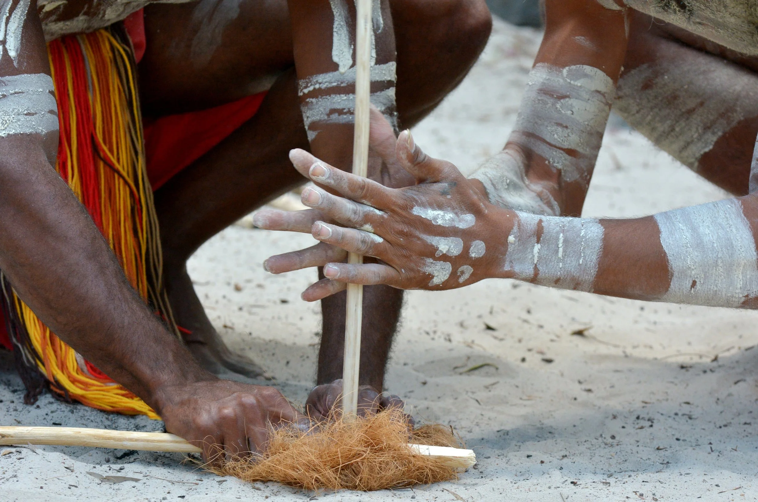 Hands of Yugambeh Aboriginal warriors demonstrate traditional fire-making craft during an Aboriginal culture show in Tasmania, Australia.