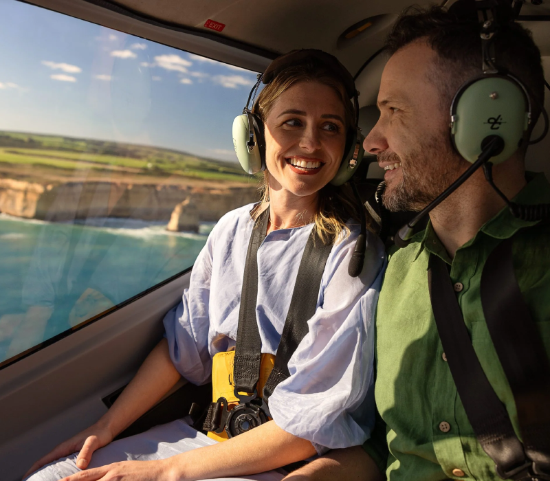 A couple on a private helicopter ride to the Twelve Apostles of the Great Ocean Road in Australia.