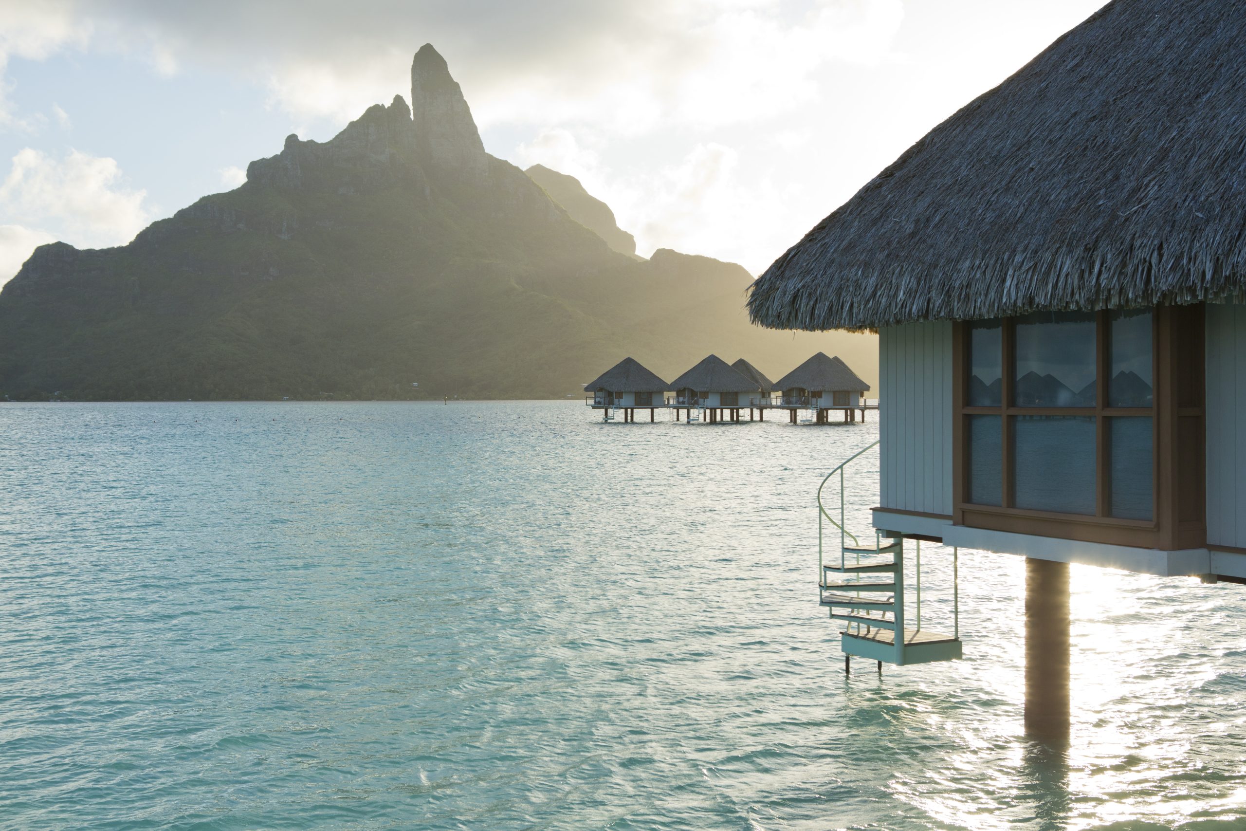 Overwater bungalow in Bora Bora. The water is clear and calm.