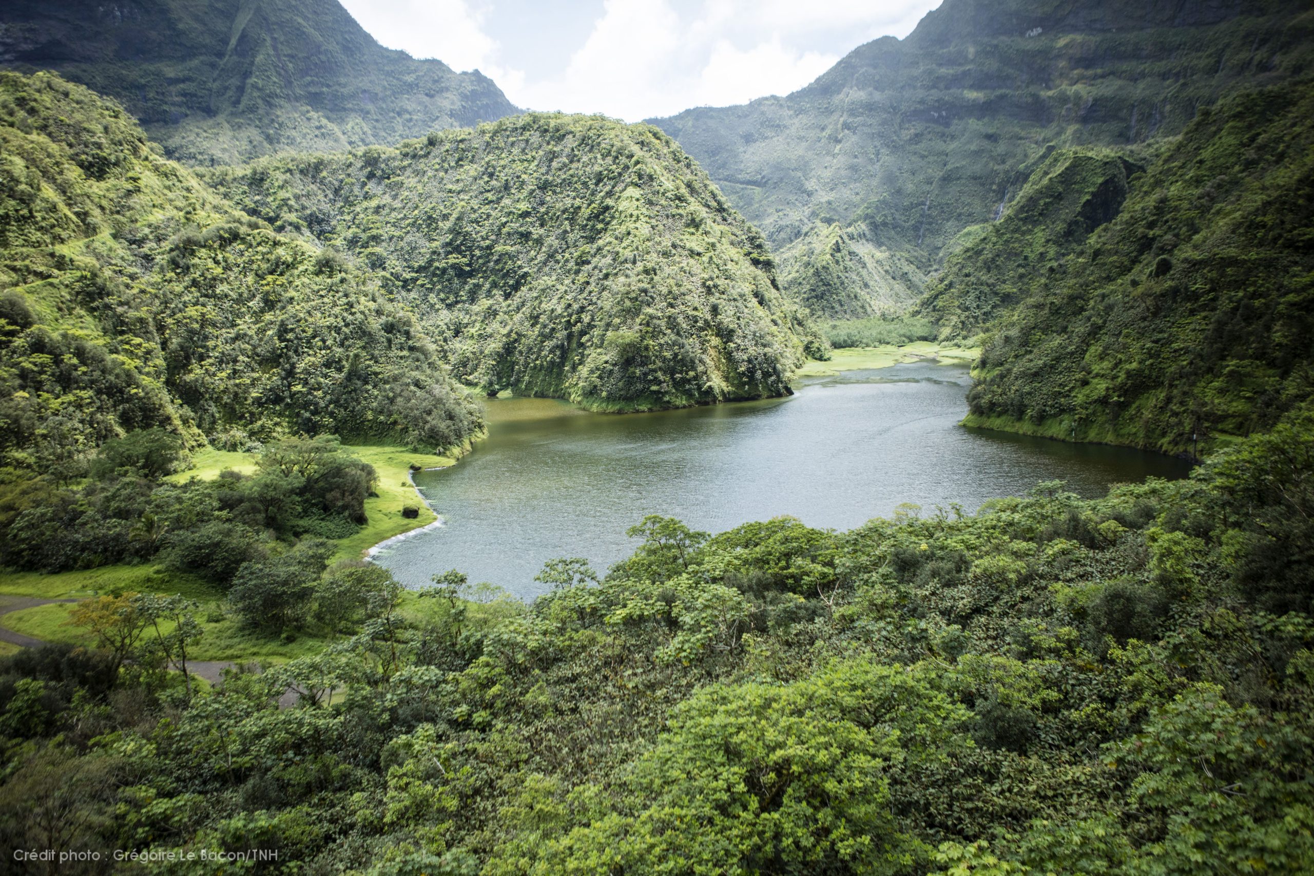 Tahiti’s stunning green mountains and lakes viewed from a helicopter tour.